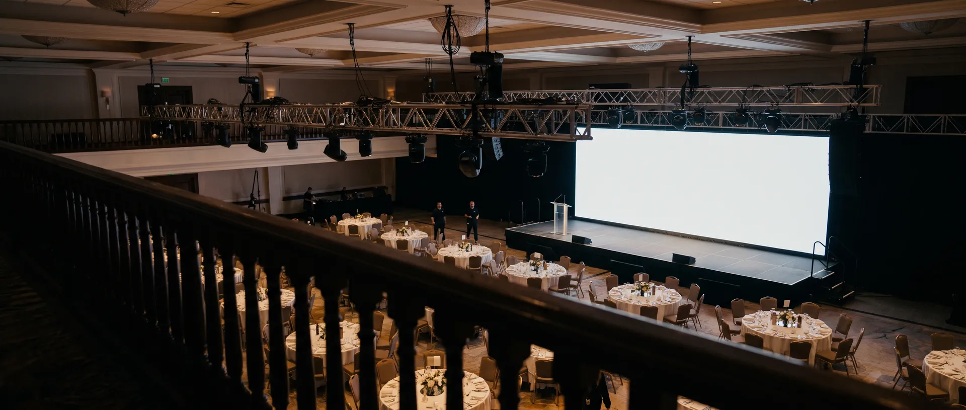 Corporate ballroom being prepared, balcony vantage